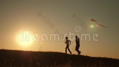 一个幸福的家庭。 一家人在夏天的夕阳下发射风筝飞向天空。